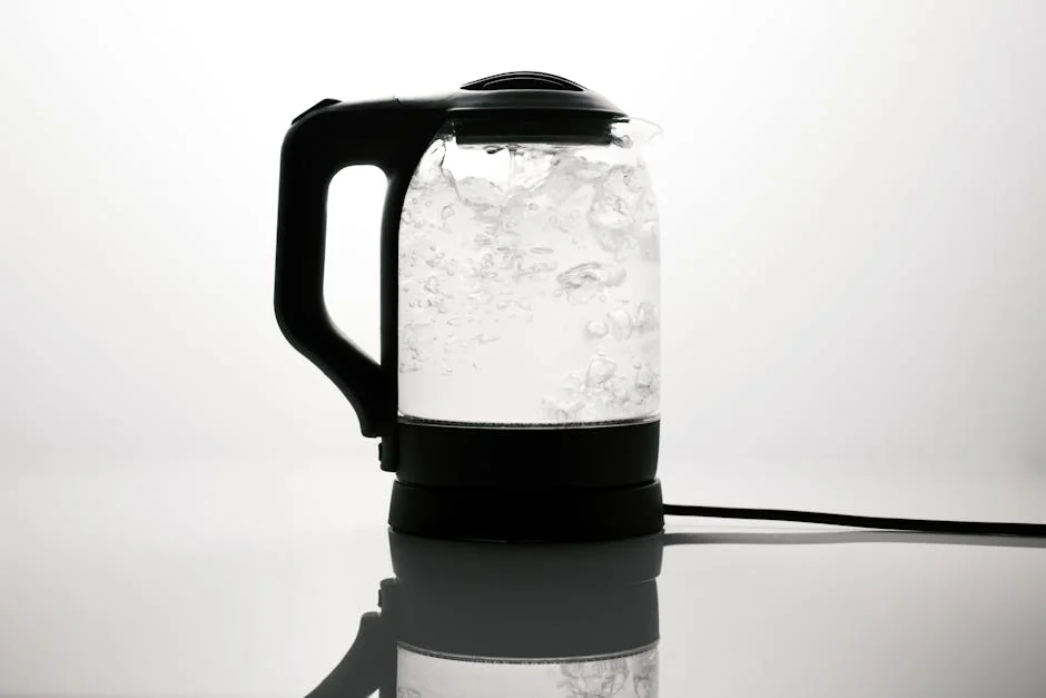 A sleek electric kettle boiling water, captured on a reflective white surface. - affordable electric kettles with temperature control