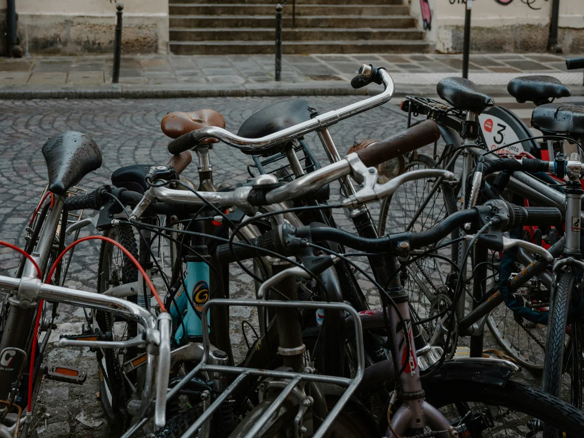 A group of bicycles parked on a cobblestone street. - best bike locks for urban commuting