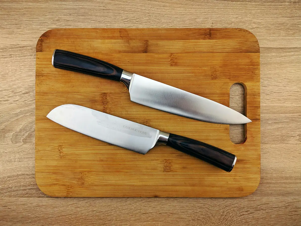 a couple of knives sitting on top of a cutting board - best kitchen knives for home chefs on a budget