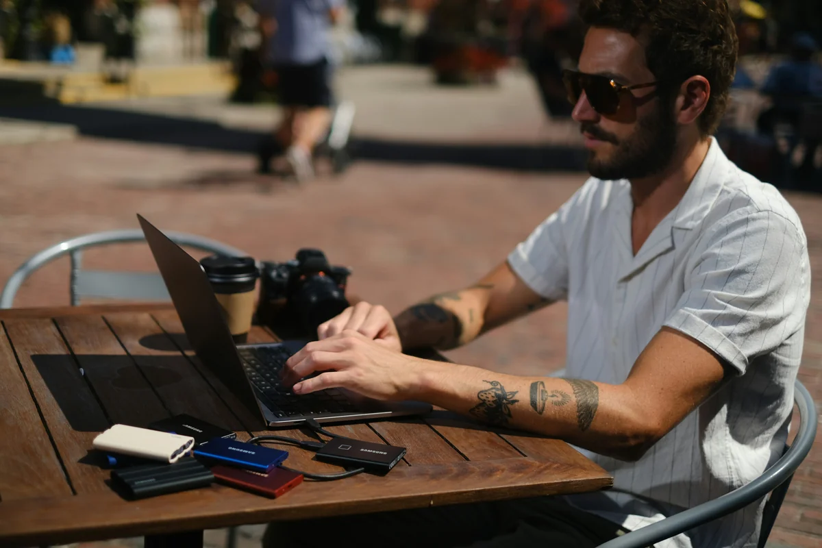 a man using a laptop - best minimalist wallets for men with rfid blocking