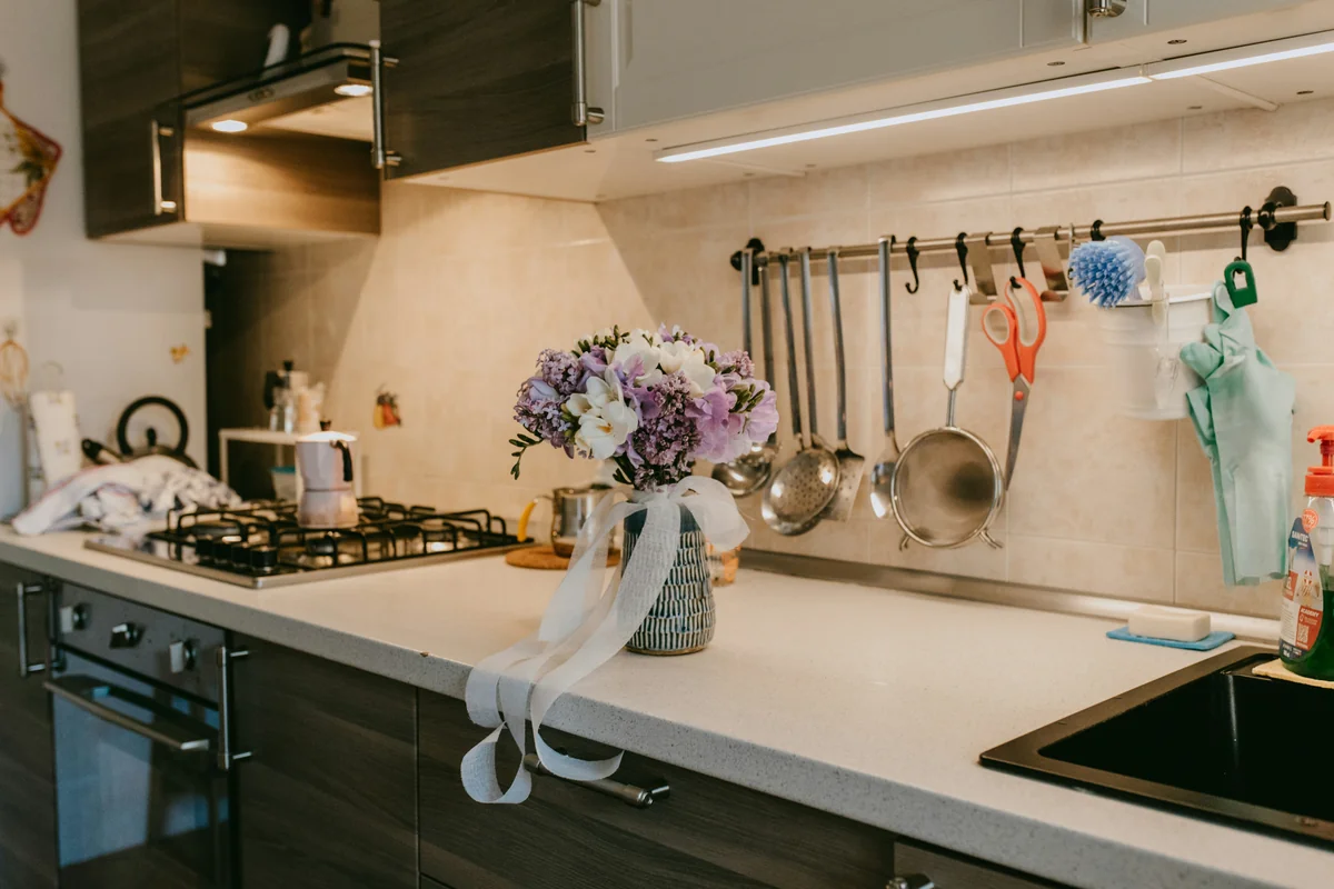 a kitchen counter with a vase of flowers on it - best multipurpose cleaning sprays for kitchens