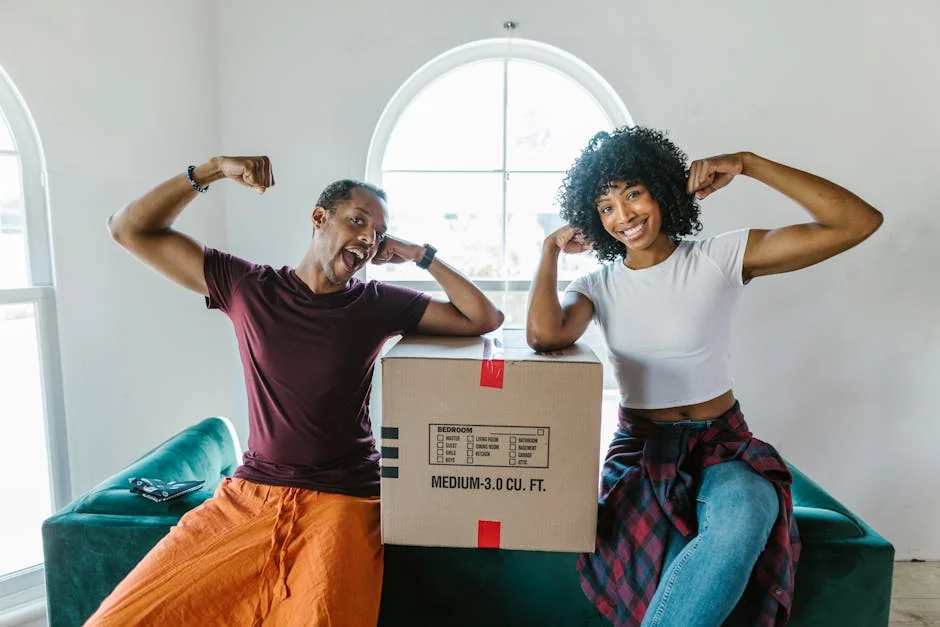 Joyful couple flexing muscles while unpacking in their new home. - best product reviews for small apartments