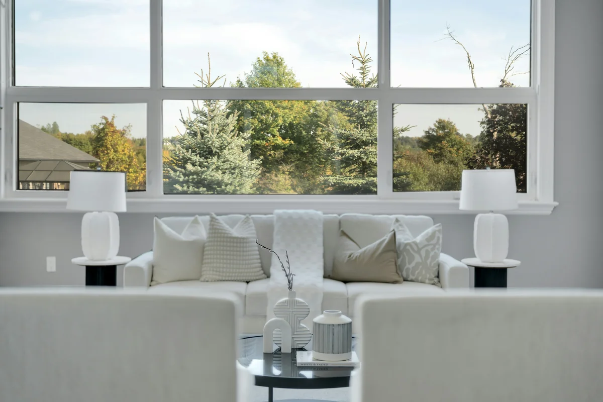 Modern living room with large window overlooking trees - best value air purifiers for large living rooms