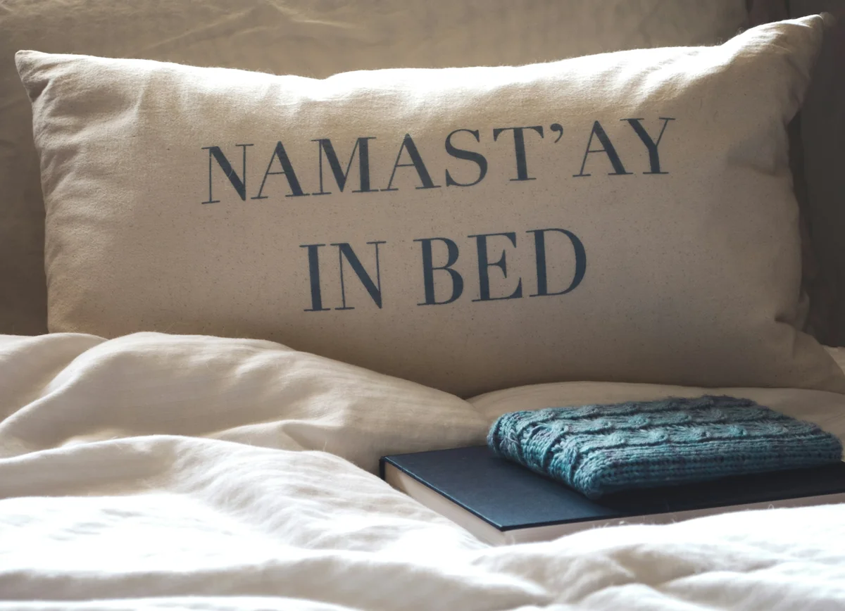 a laptop on a bed - rest relaxation bedroom - best weighted blankets for anxiety and sleep