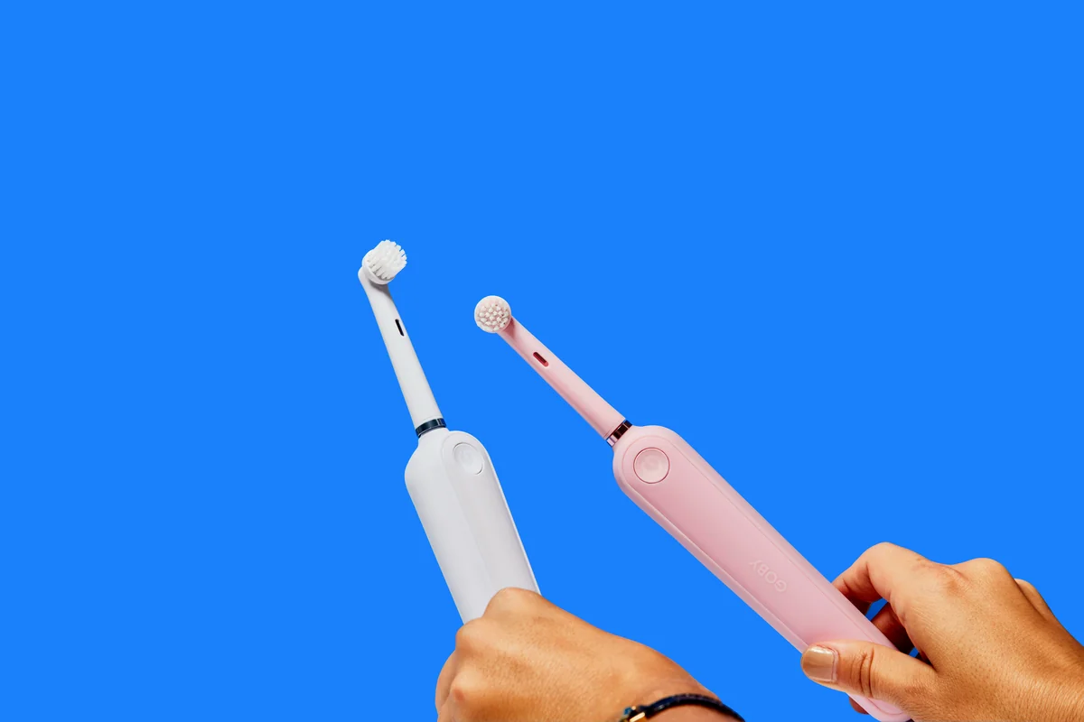 two white electric toothbrushes - budget friendly electric toothbrushes with long battery life