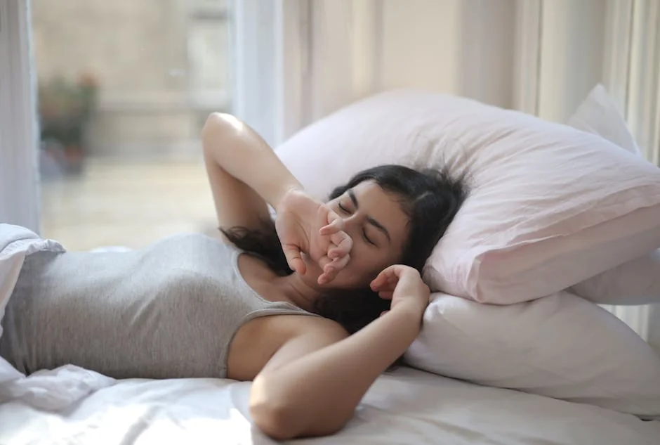 A woman resting comfortably indoors on a cozy bed, perfect for lifestyle or relaxation themes. - rest relaxation bedroom - highly rated memory foam pillows for side sleepers