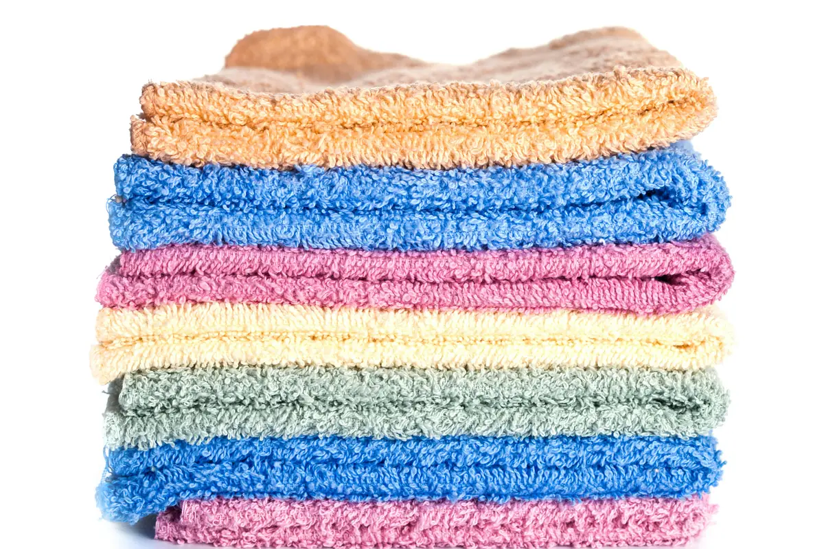 A stack of multicolored towels on a white background - most durable bath towels for everyday use