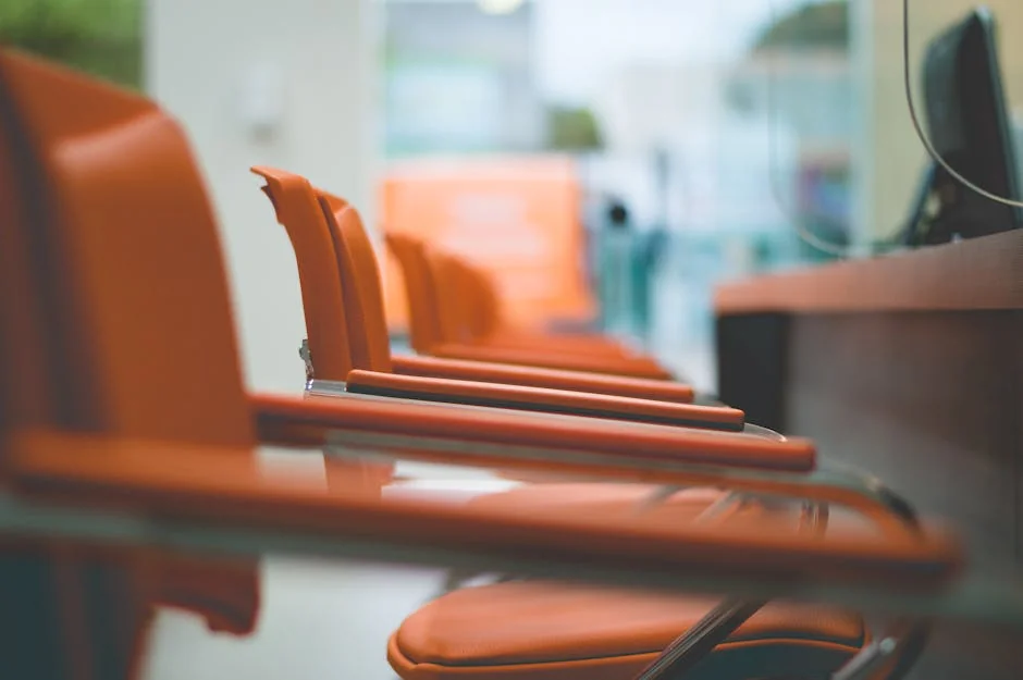 Close-up of sleek orange office chairs in a waiting area with focus on design. - top rated ergonomic office chairs for back pain