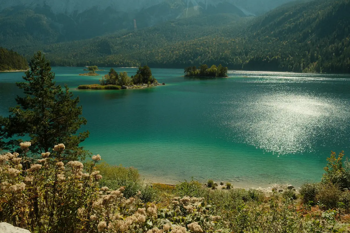 Turquoise lake with islands and mountains in background - adventure vacation destination - top rated handheld garment steamers for travel