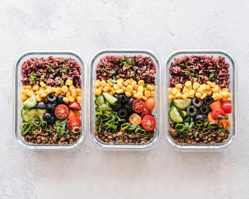 Colorful healthy meal prep with corn, olives, tomatoes, and lentils in glass containers. Perfect for mindful eating. - top rated meal prep containers for long term use