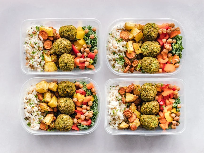 Colorful meal prep containers with falafel, chickpeas, rice, and vegetables for a healthy lifestyle. - top rated meal prep containers for long term use