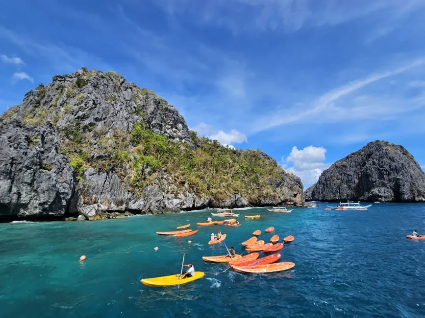 A vibrant scene of kayakers exploring the limestone cliffs in El Nido, Philippines. - adventure vacation destination - top rated portable power banks for travel