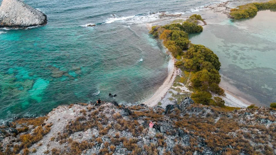 Aerial shot of a tropical island with clear turquoise waters and lush greenery, perfect for a serene escape. - adventure vacation destination - top rated portable power banks for travel